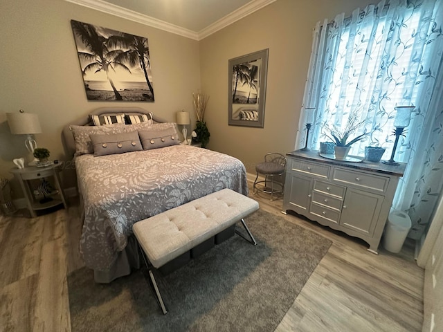 bedroom featuring light wood-type flooring and crown molding