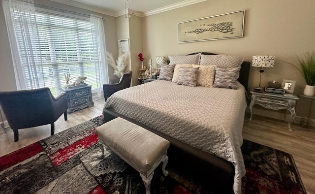 bedroom featuring wood finished floors and ornamental molding