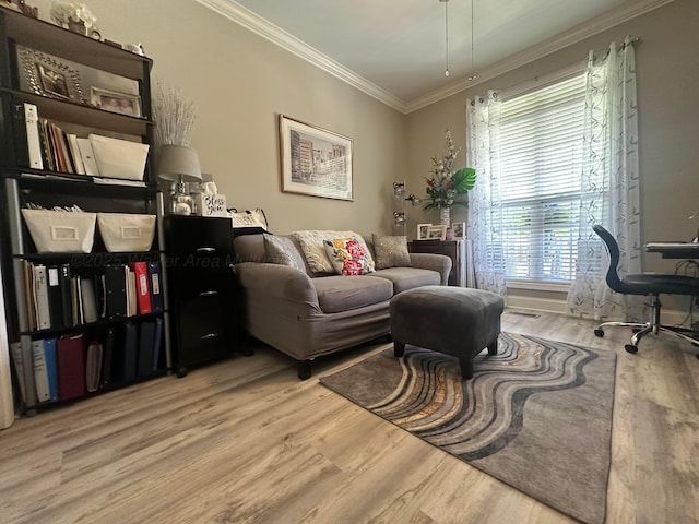sitting room featuring crown molding and wood finished floors