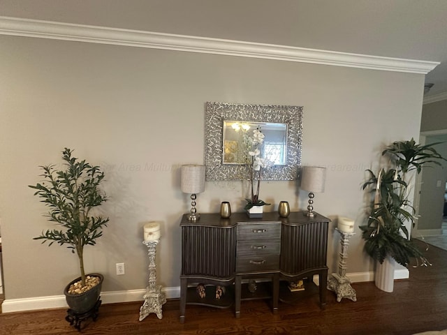 detailed view of ornamental molding, wood finished floors, and baseboards