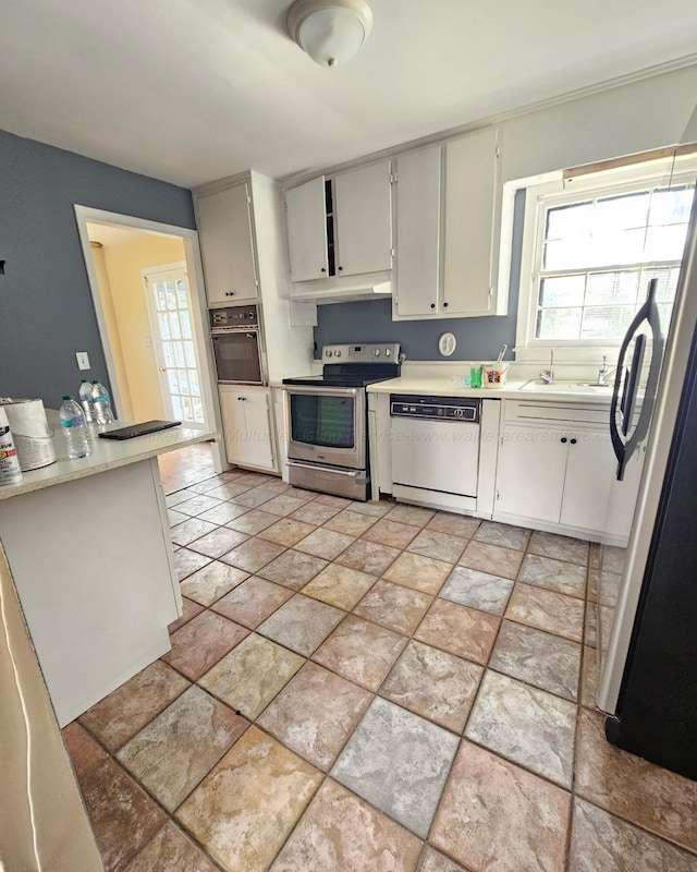 1332 4th Way, Birmingham, AL 35215 - kitchen featuring stainless steel appliances, under cabinet range hood, healthy amount of natural light, and light countertops