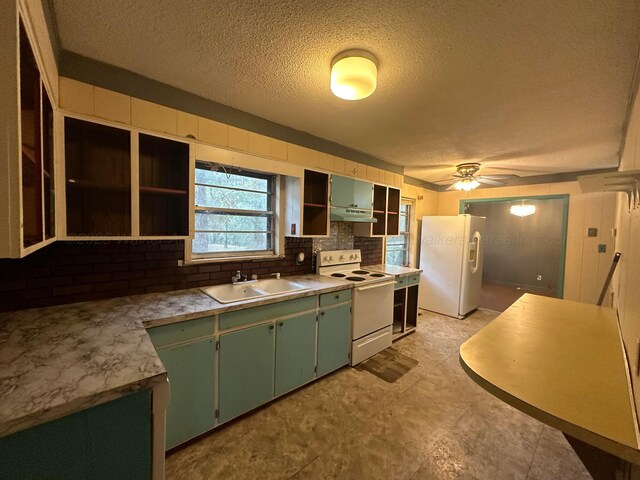 47 Hyche Rd, Cordova, AL 35550 - kitchen with white appliances, a sink, green cabinets, open shelves, and a textured ceiling