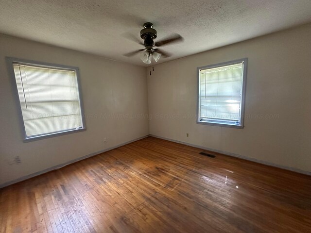47 Hyche Rd, Cordova, AL 35550 - unfurnished room with ceiling fan, wood-type flooring, baseboards, and a textured ceiling