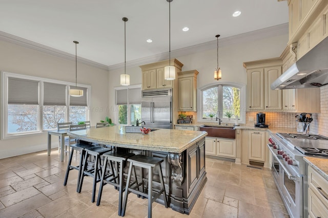 930 County Road 175, Crane Hill, AL 35053 - kitchen with high end appliances, cream cabinetry, a sink, and stone tile floors