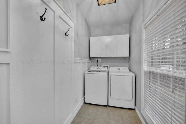 washroom featuring cabinet space, light tile patterned floors, and independent washer and dryer