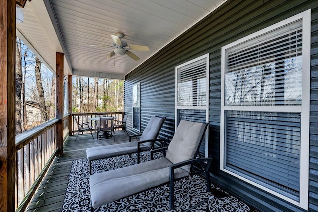 wooden deck featuring ceiling fan and outdoor dining space