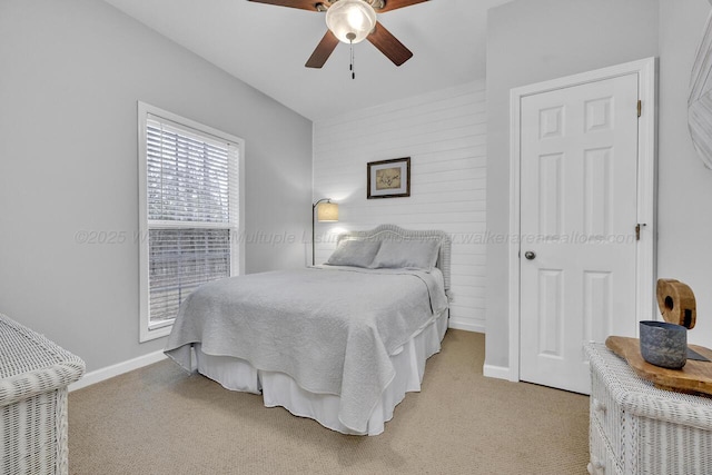 bedroom with light carpet, a ceiling fan, and baseboards