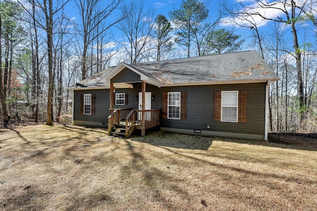 view of front facade with a shingled roof, a front yard, and crawl space