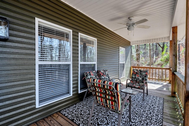 wooden deck featuring a ceiling fan