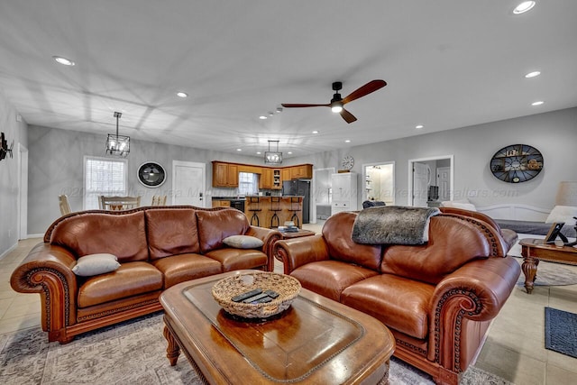 living area with light tile patterned floors, ceiling fan, and recessed lighting