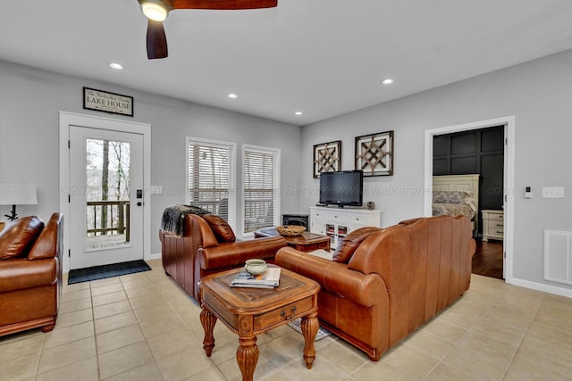 living room featuring baseboards, light tile patterned flooring, visible vents, and recessed lighting