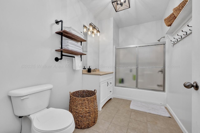 full bathroom with bath / shower combo with glass door, baseboards, toilet, tile patterned flooring, and vanity