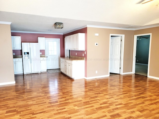 kitchen featuring crown molding, white refrigerator with ice dispenser, light wood-style floors, ceiling fan, and white cabinets