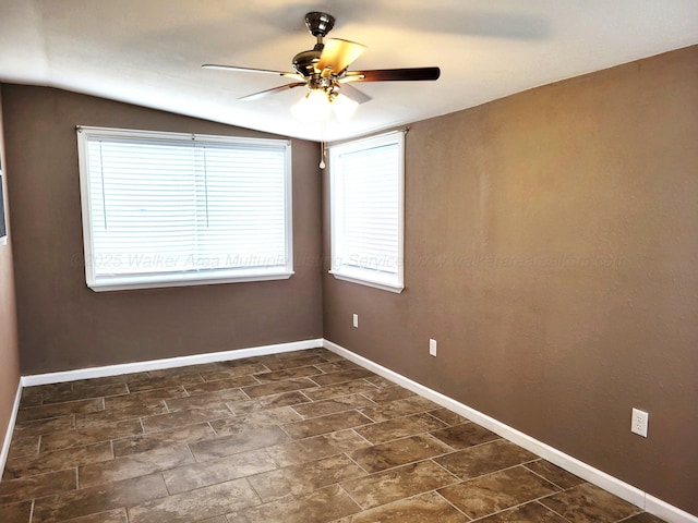 spare room featuring baseboards, lofted ceiling, and a ceiling fan