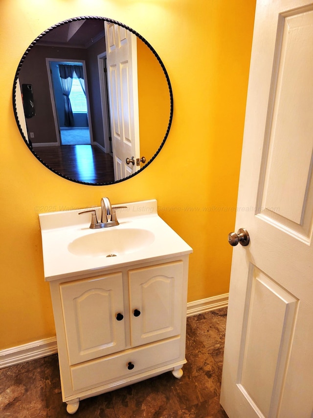 bathroom featuring baseboards and vanity