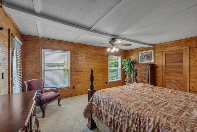 60 County Road 304, Cullman, AL 35057 - bedroom with a textured ceiling, wood walls, light colored carpet, and ceiling fan