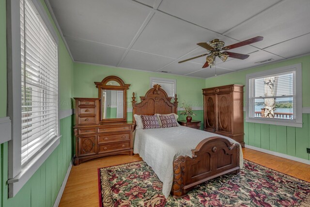 60 County Road 304, Cullman, AL 35057 - bedroom featuring light wood finished floors, a wainscoted wall, and a ceiling fan