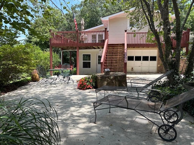 60 County Road 304, Cullman, AL 35057 - rear view of property with an attached garage, stairway, a wooden deck, and a patio