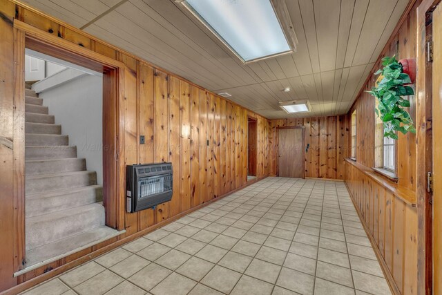60 County Road 304, Cullman, AL 35057 - unfurnished room featuring heating unit, wood walls, stairs, and light tile patterned floors