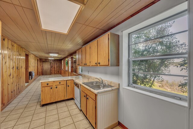 60 County Road 304, Cullman, AL 35057 - kitchen featuring light countertops, a peninsula, wooden walls, light tile patterned flooring, and white dishwasher