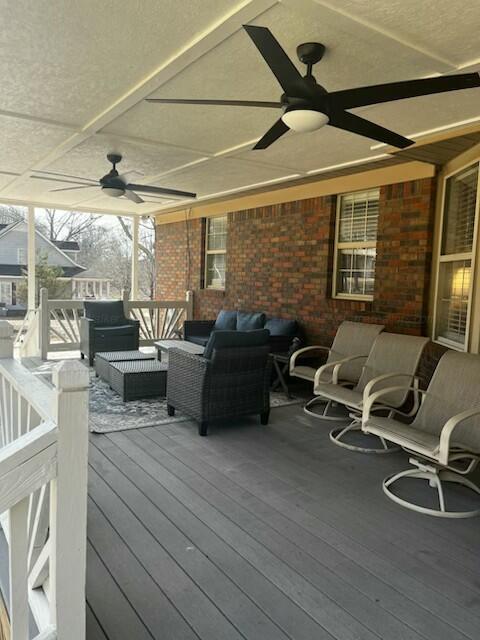 deck featuring an outdoor hangout area and ceiling fan