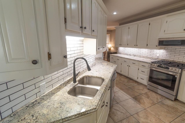 kitchen featuring decorative backsplash, white cabinetry, a sink, and appliances with stainless steel finishes