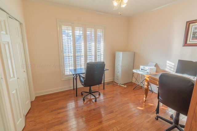 office featuring a ceiling fan, ornamental molding, hardwood / wood-style flooring, and baseboards