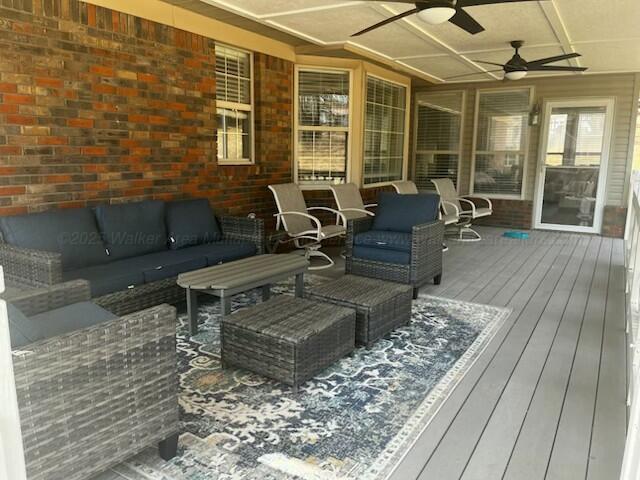 deck with an outdoor hangout area and ceiling fan