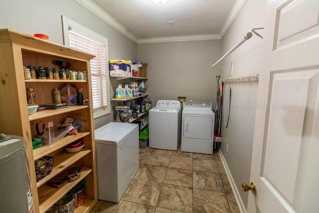 laundry room with washing machine and clothes dryer, crown molding, baseboards, and laundry area
