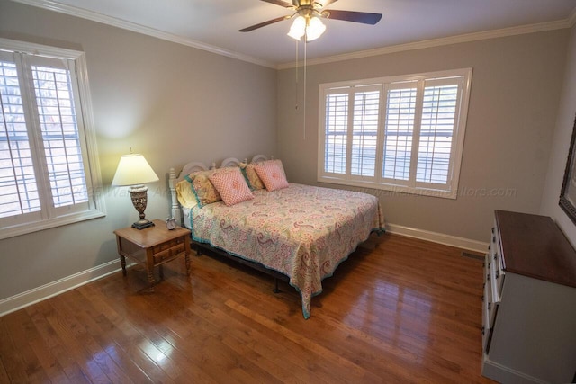 bedroom with baseboards, ornamental molding, wood finished floors, and multiple windows