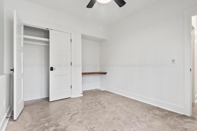 unfurnished bedroom featuring concrete flooring, ceiling fan, baseboards, and a closet