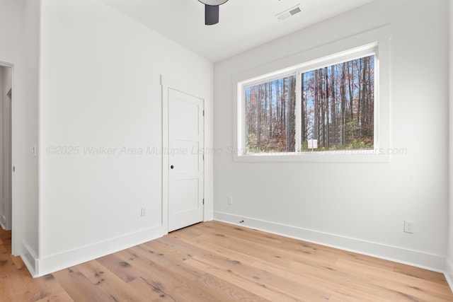 unfurnished bedroom featuring baseboards, visible vents, light wood-style floors, and ceiling fan