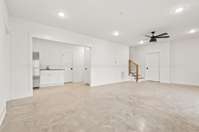 unfurnished room featuring concrete flooring, visible vents, stairs, and recessed lighting