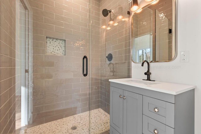 full bathroom with vanity and a shower stall