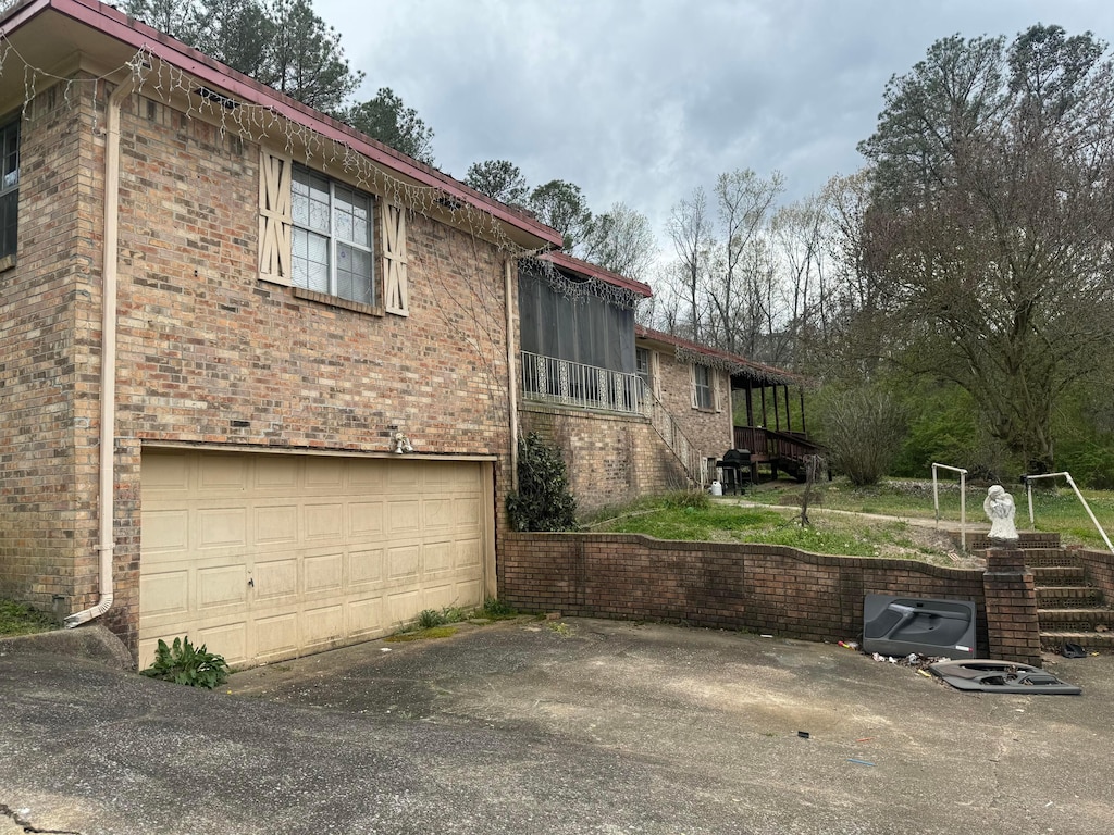 1001 26th St, Jasper, AL 35501 - view of home's exterior with brick siding, an attached garage, and driveway