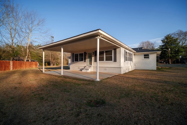 back of house featuring a yard, fence, and a patio area