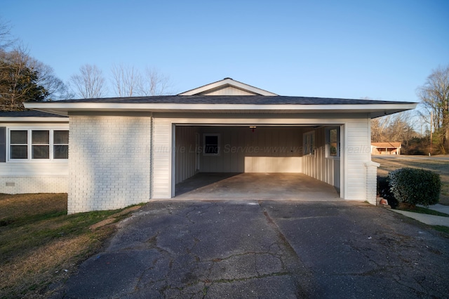garage featuring aphalt driveway