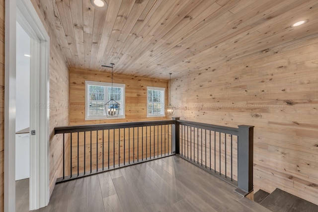 bonus room with wood finished floors, recessed lighting, wood ceiling, and wood walls