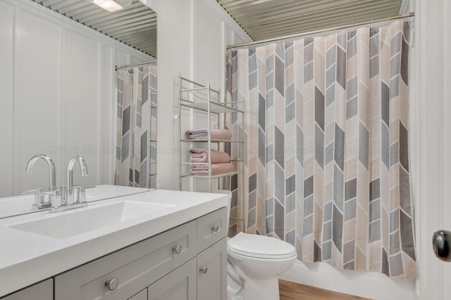 bathroom featuring toilet and vanity