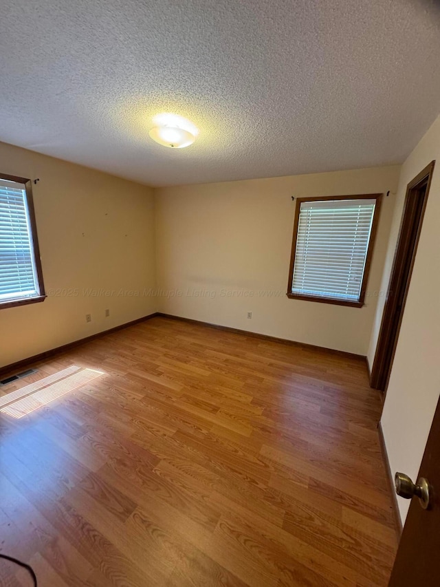 2354 Old Parrish Rd, Parrish, AL 35580 - unfurnished room featuring a textured ceiling, light wood-type flooring, and baseboards