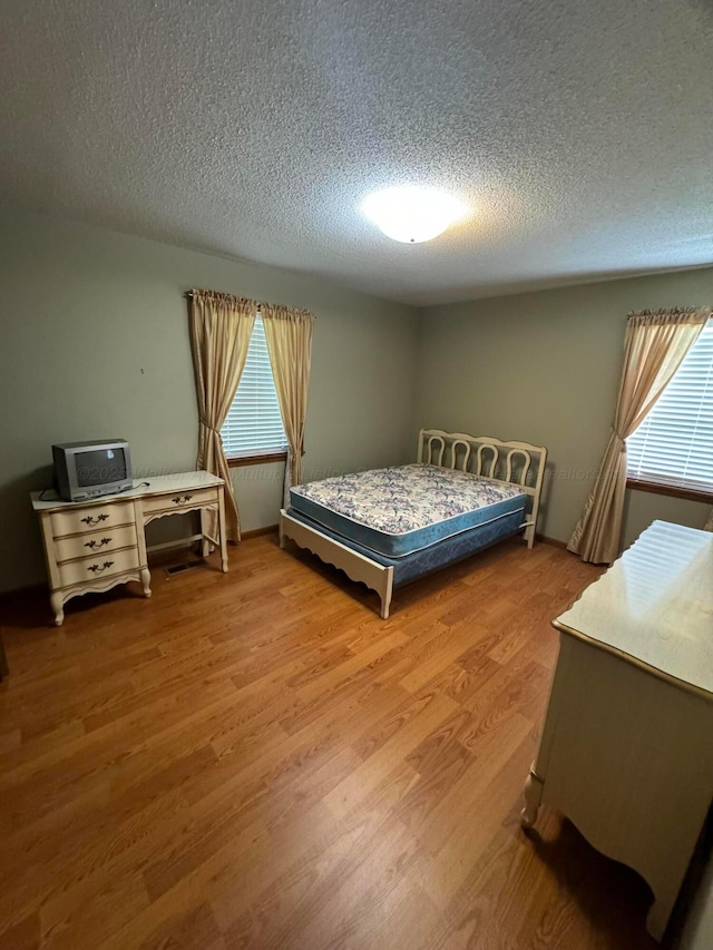 2354 Old Parrish Rd, Parrish, AL 35580 - bedroom with a textured ceiling and wood finished floors