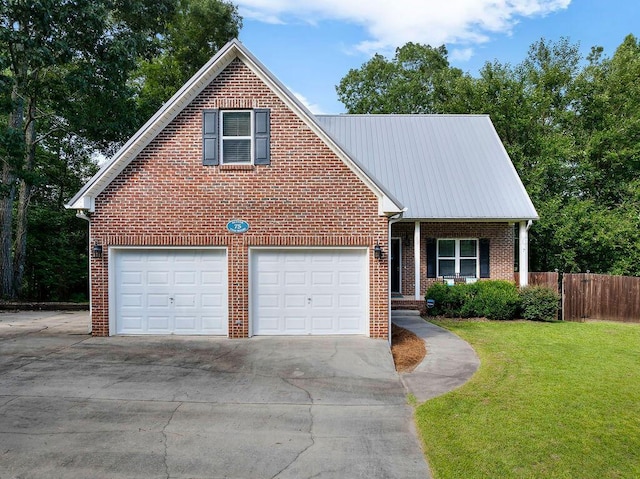 75 County Rd 881, Crane Hill, AL 35053 - traditional home featuring brick siding, concrete driveway, a metal roof, covered porch, and an attached garage