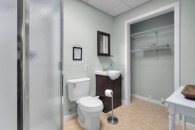 75 County Rd 881, Crane Hill, AL 35053 - bathroom with vanity, a paneled ceiling, a spacious closet, tile patterned flooring, and a shower with door