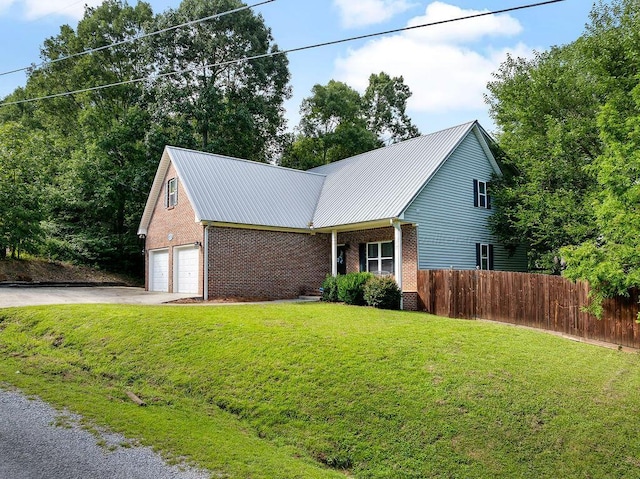 75 County Rd 881, Crane Hill, AL 35053 - view of front of home featuring driveway, brick siding, a garage, and a metal roof
