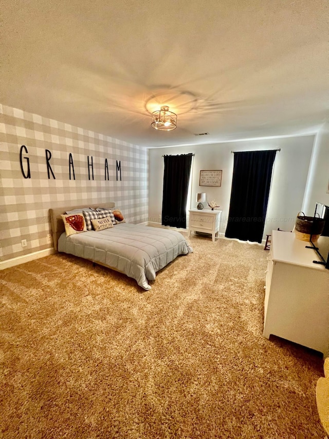 305 Chris Ln, Winfield, AL 35594 - carpeted bedroom featuring baseboards, visible vents, a textured ceiling, and wallpapered walls