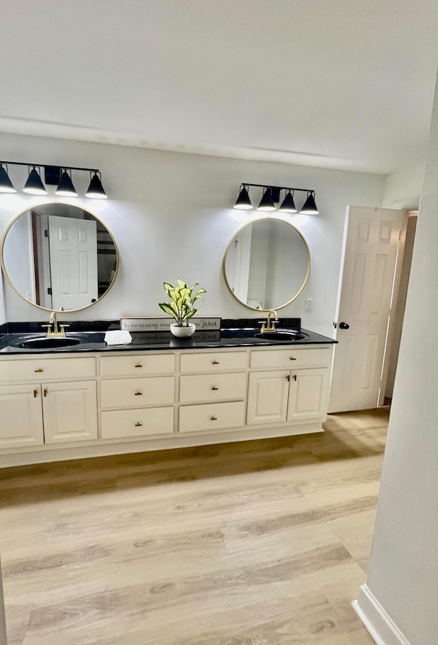 305 Chris Ln, Winfield, AL 35594 - bathroom featuring double vanity, a sink, and wood finished floors