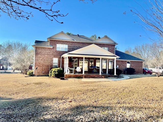 305 Chris Ln, Winfield, AL 35594 - back of house with brick siding, a lawn, and a patio