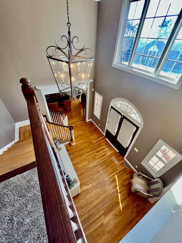 305 Chris Ln, Winfield, AL 35594 - entryway with baseboards, visible vents, wood finished floors, and an inviting chandelier