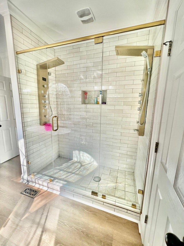 305 Chris Ln, Winfield, AL 35594 - full bathroom featuring visible vents, a shower stall, and wood finished floors