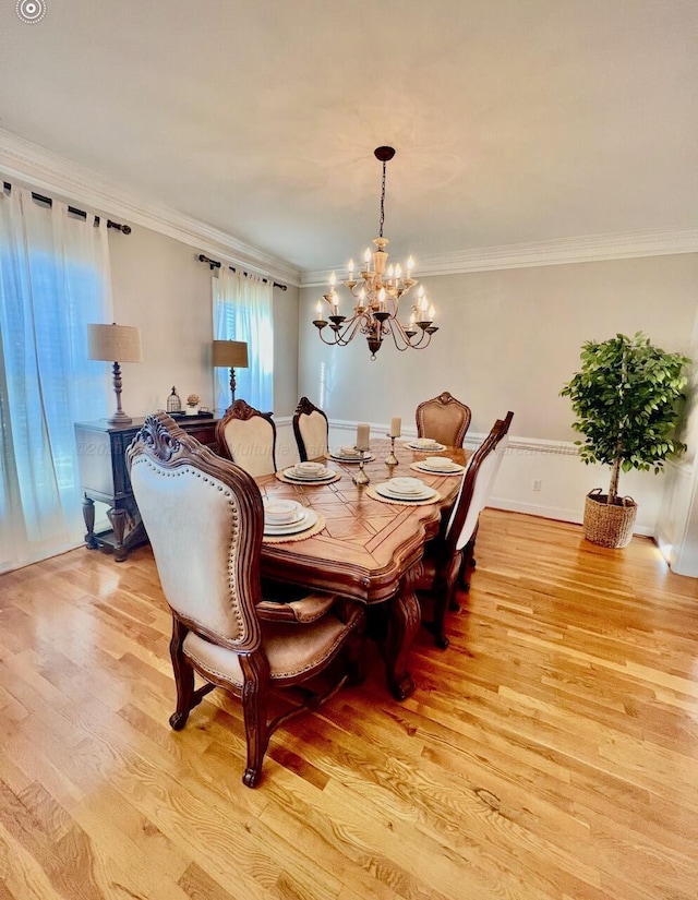 305 Chris Ln, Winfield, AL 35594 - dining area with a notable chandelier, crown molding, and light wood-type flooring